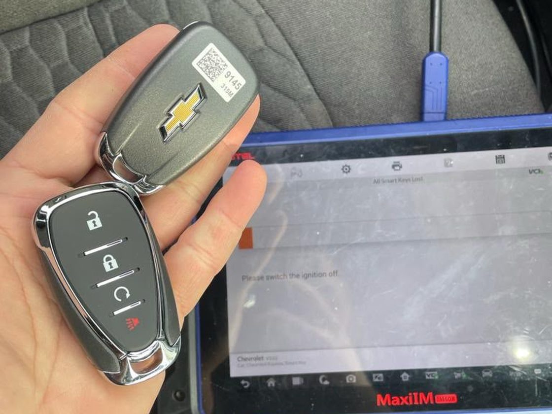 Two Chevrolet smart keys beside an Autel key programmer showing All Smart Keys Lost
